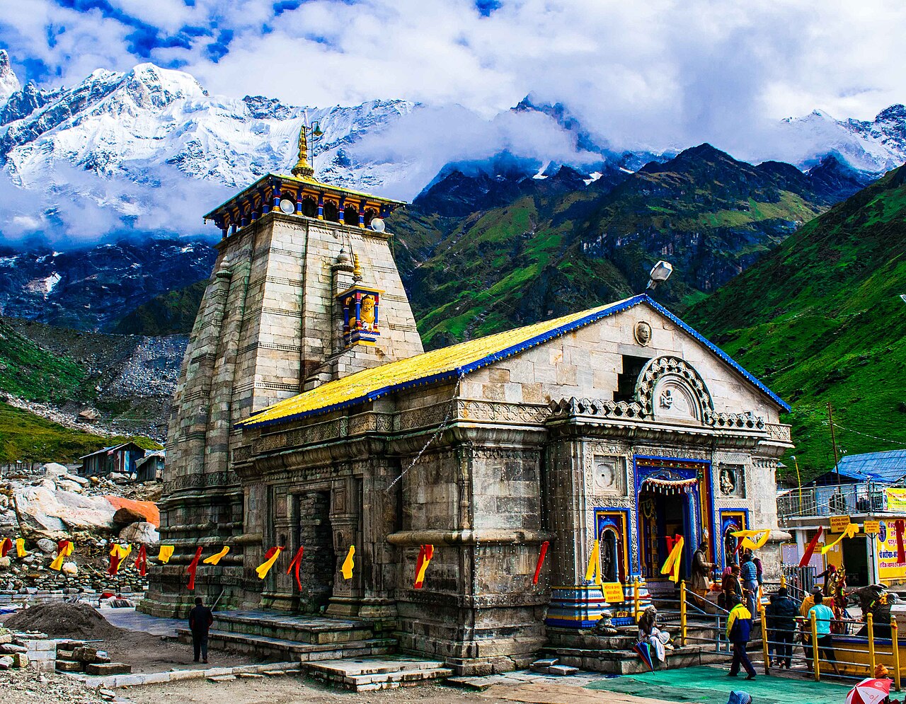 Sacred stone shrine of Kedarnath Temple standing proudly before snow-covered Himalayan peaks