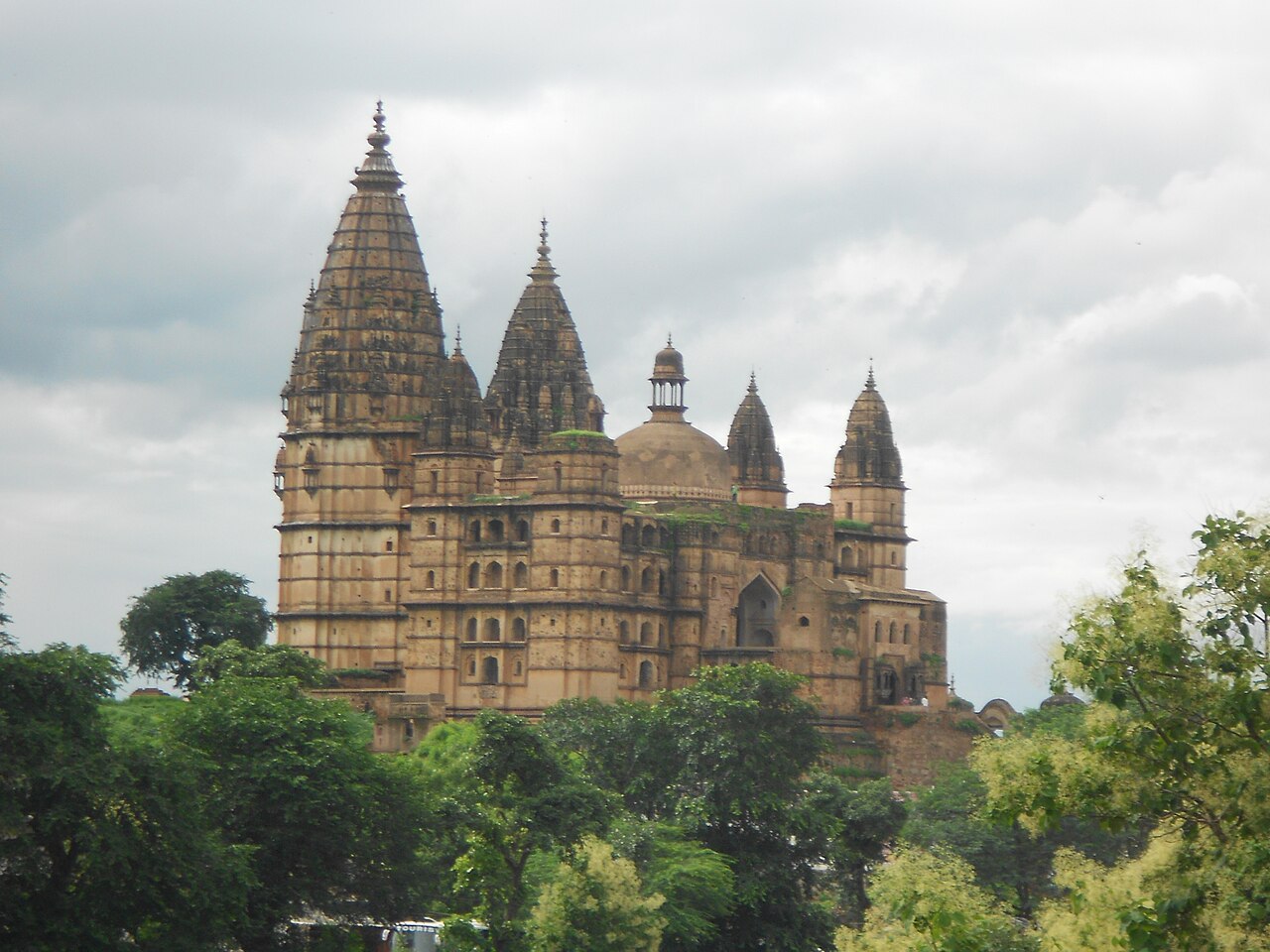 Royal cenotaphs (Chhatris) of Orchha reflected in the Betwa River at sunset