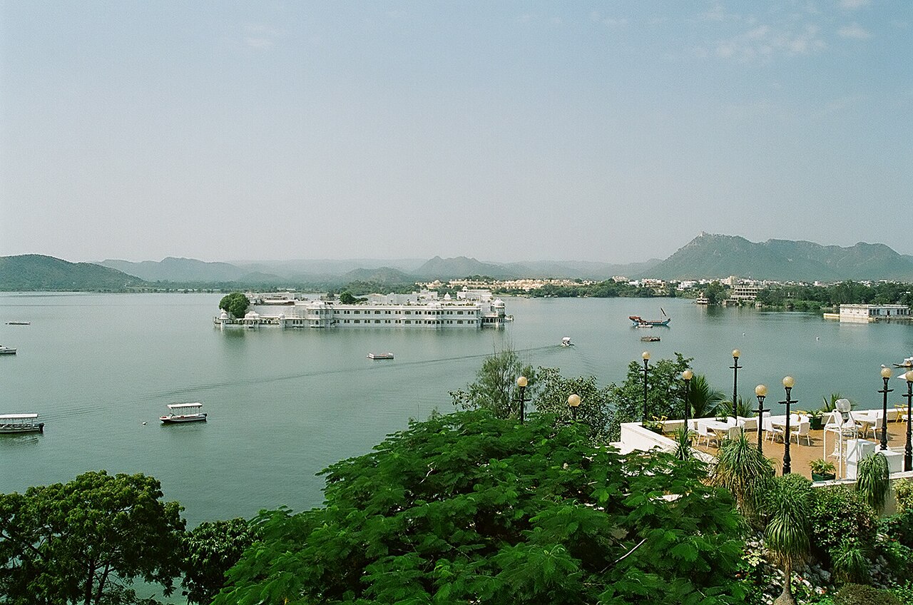 Lake Palace and Aravalli hills mirrored across the shimmering waters of Lake Pichola