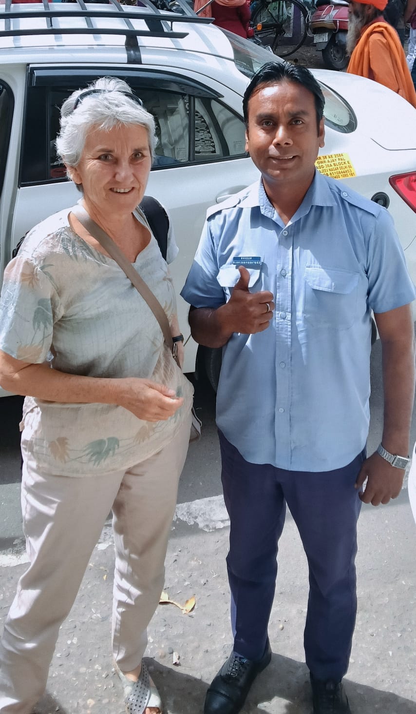 Private driver India with guest beside the tour car