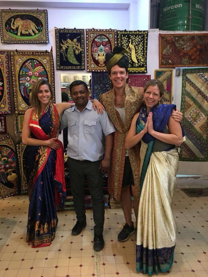 Foreign tourists shopping for handicrafts in Jaipur bazaar during Diwali tour with private driver
